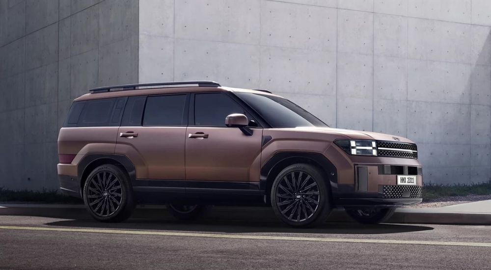 A bronze 2025 Hyundai Santa Fe is shown from the side after leaving a Hyundai dealer near Kenosha.