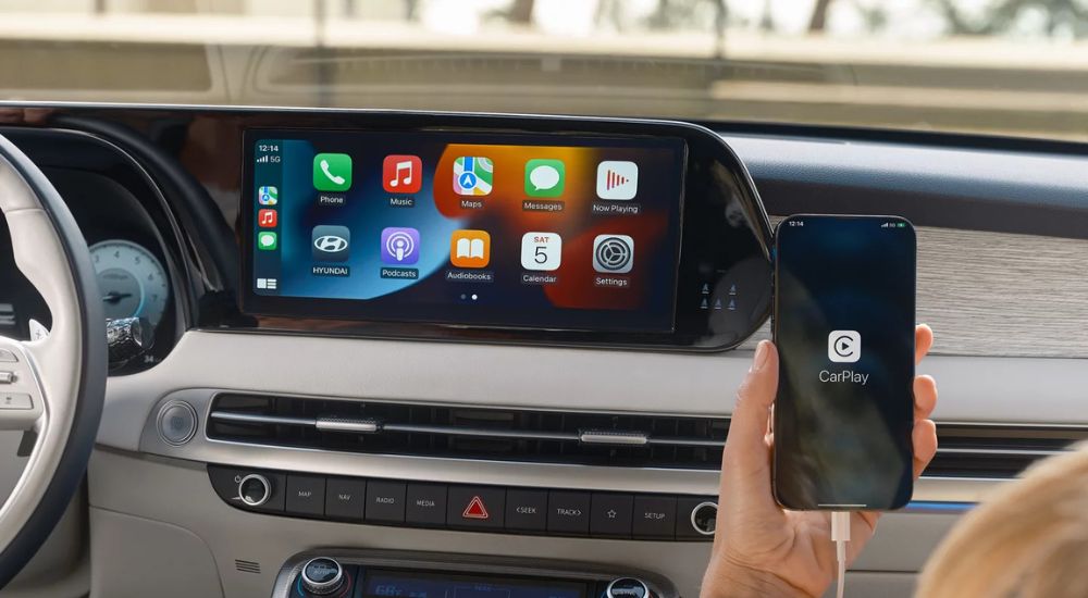 A passenger using Apple CarPlay in a 2025 Hyundai Palisade.