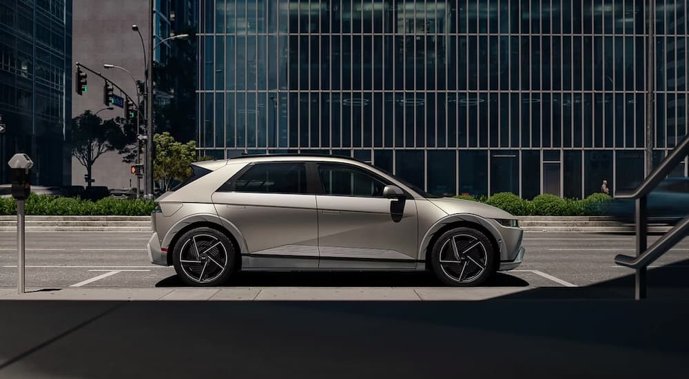 A tan 2025 Hyundai IONIQ 5 parked in a city after viewing electric vehicles for sale.