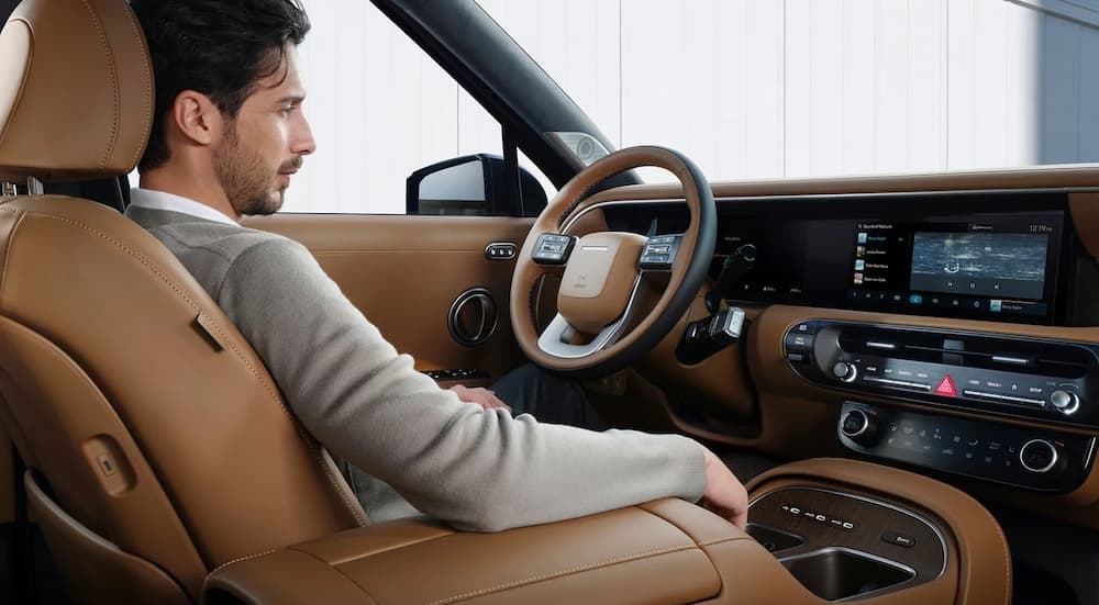 A person driving in a 2026 Hyundai Palisade for sale near Libertyville.