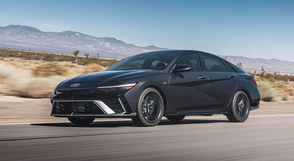 A gray 2026 Hyundai Elantra driving on a highway.