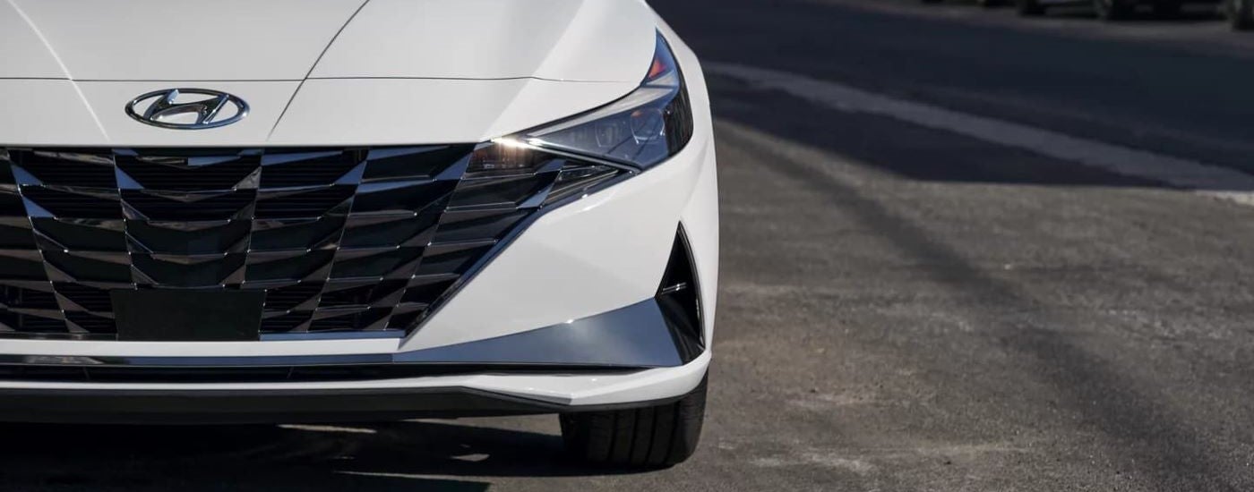 Close-up on the front and grille of a white 2021 Hyundai Elantra Hybrid.