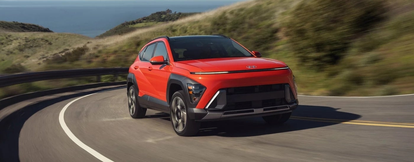 An orange 2025 Hyundai Kona from the front at an angle.