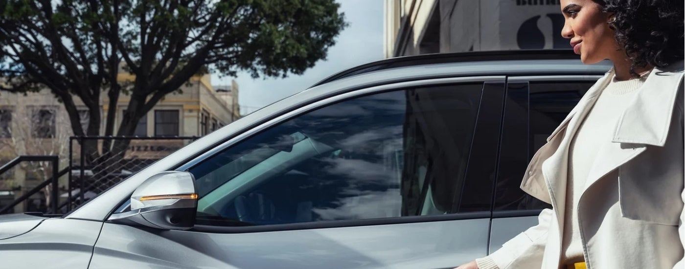 Person standing near a grey 2025 Hyundai Tucson PHEV LImited