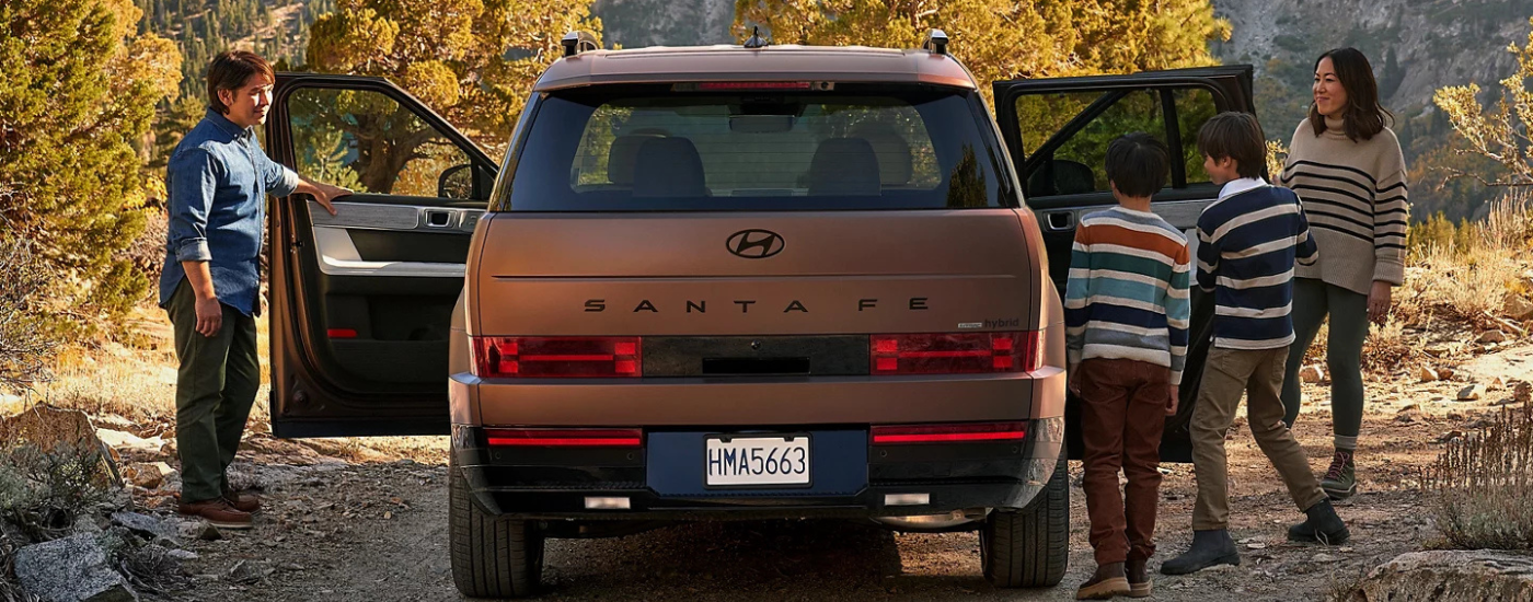 A family packing into an orange 2026 Hyundai Santa Fe