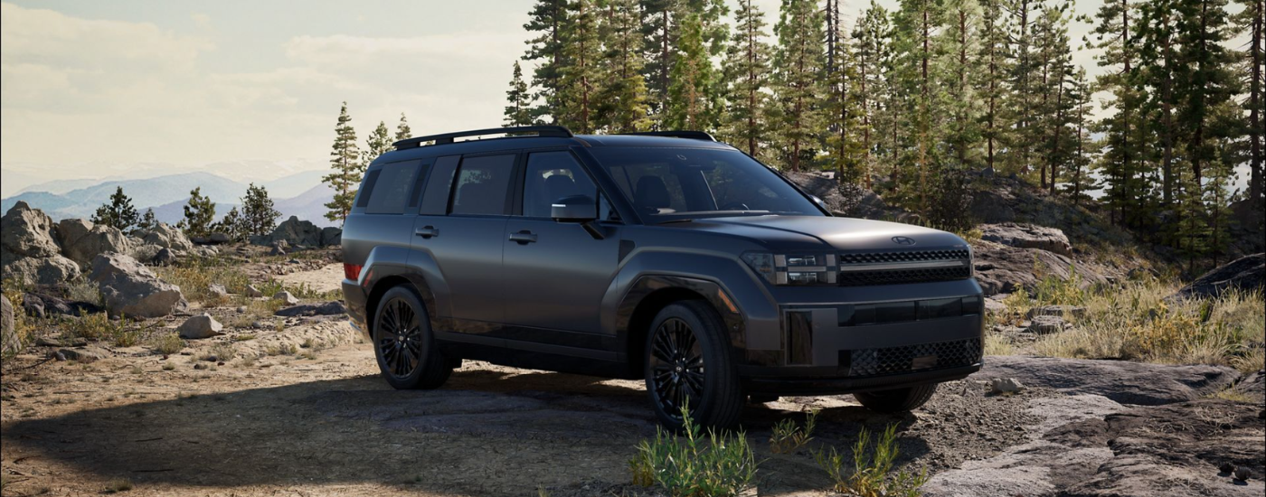 Black 2026 Hyundai Santa Fe parked off-road at an angle