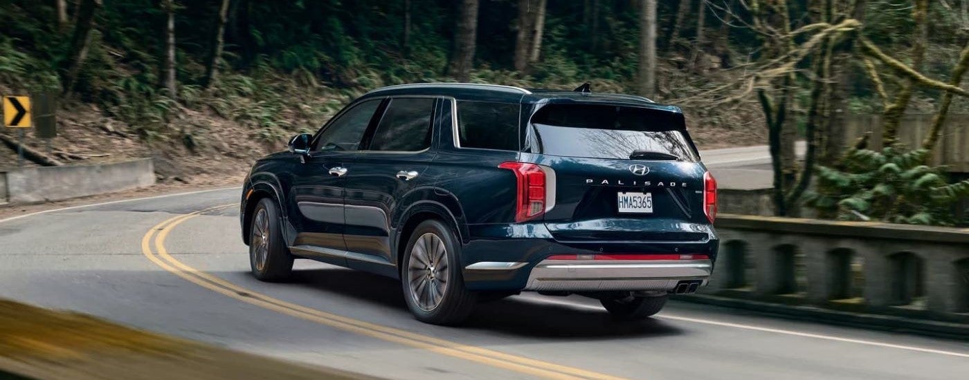 A blue 2023 Hyundai Palisade turning a corner.