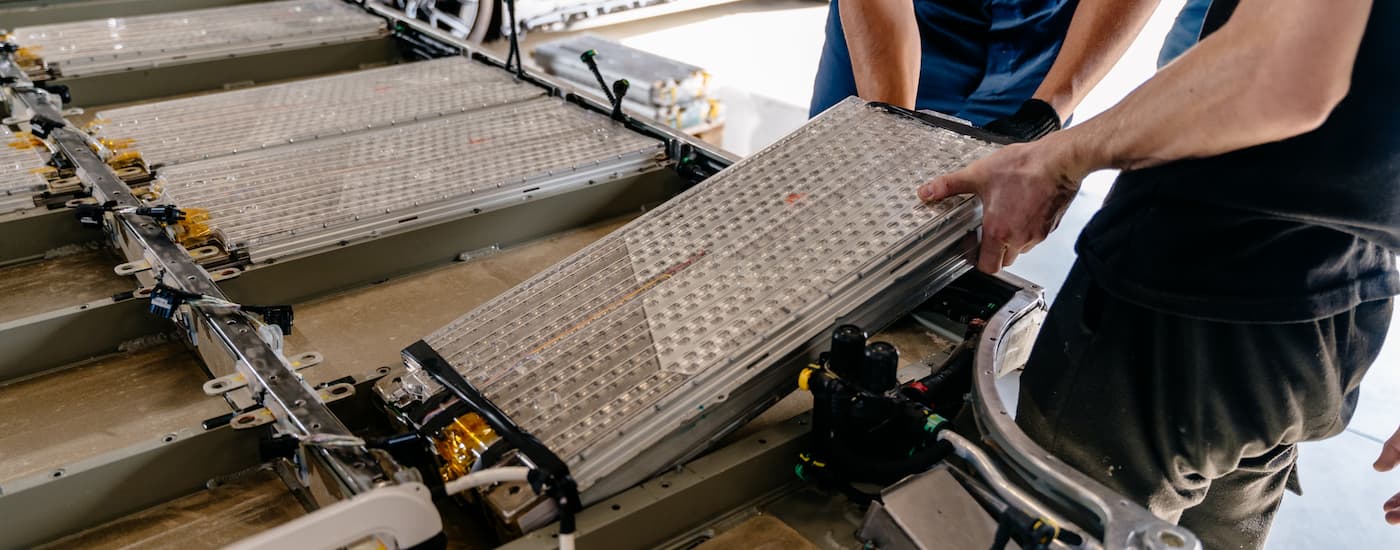 Packs of battery cells being loaded onto a platform.