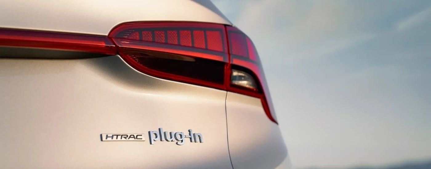 A close up shows the passenger side taillight on a silver 2023 Hyundai Santa Fe PHEV.
