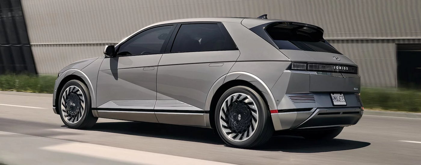 Rear view of a grey 2024 Hyundai IONIQ 5 driving to a Hyundai dealer near Libertyville.