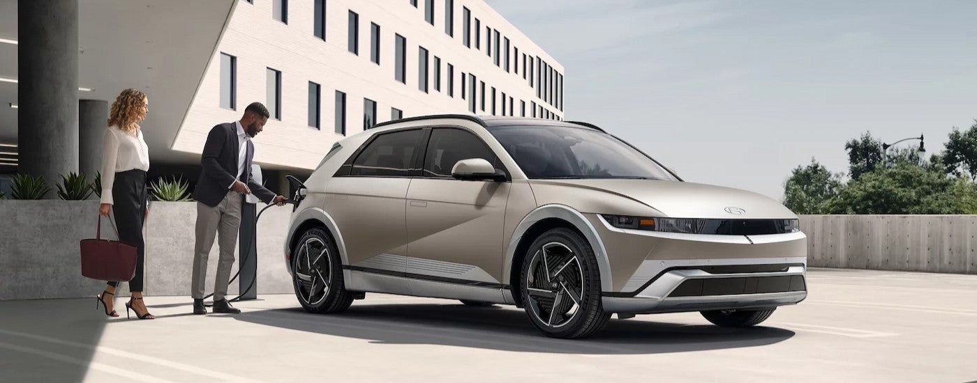 A multi-colored 2025 Hyundai IONIQ 5 parked and charging.