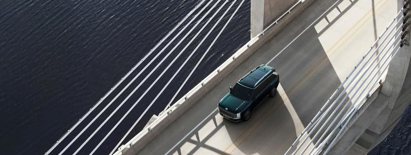 A green 2026 Hyundai driving on a bridge.