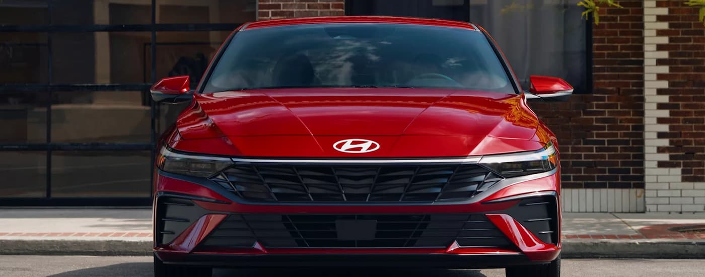 A red 2025 Hyundai Elantra parked in a city